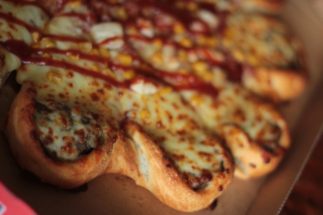 Each slice contains a slider-sized patty with a wrapped-around crust.