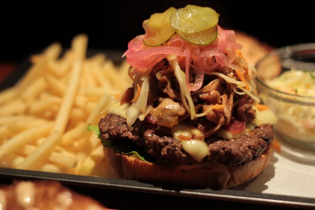Pulled pork and slaw on a beef patty.